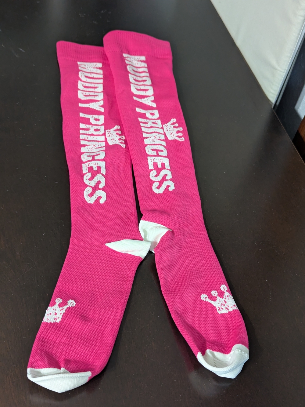 Kids pink socks with 'Muddy Princess' text